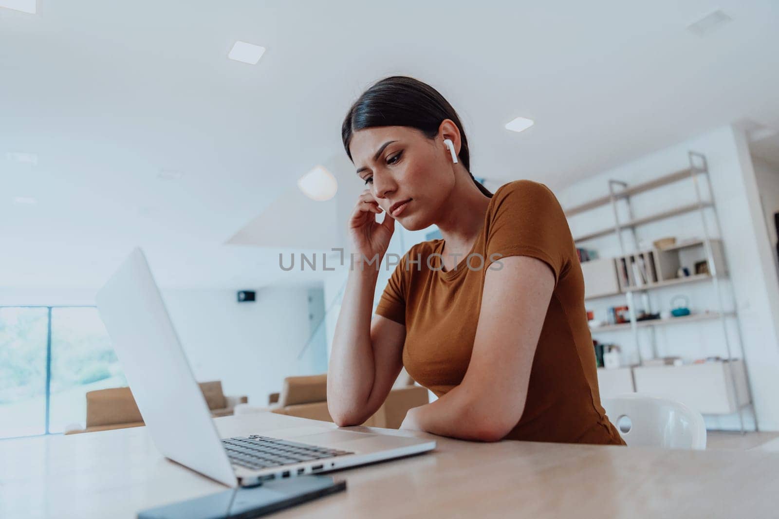 Woman sitting in living room using laptop looking at cam talk by video call with business friend relatives, head shot. Job interview answering questions