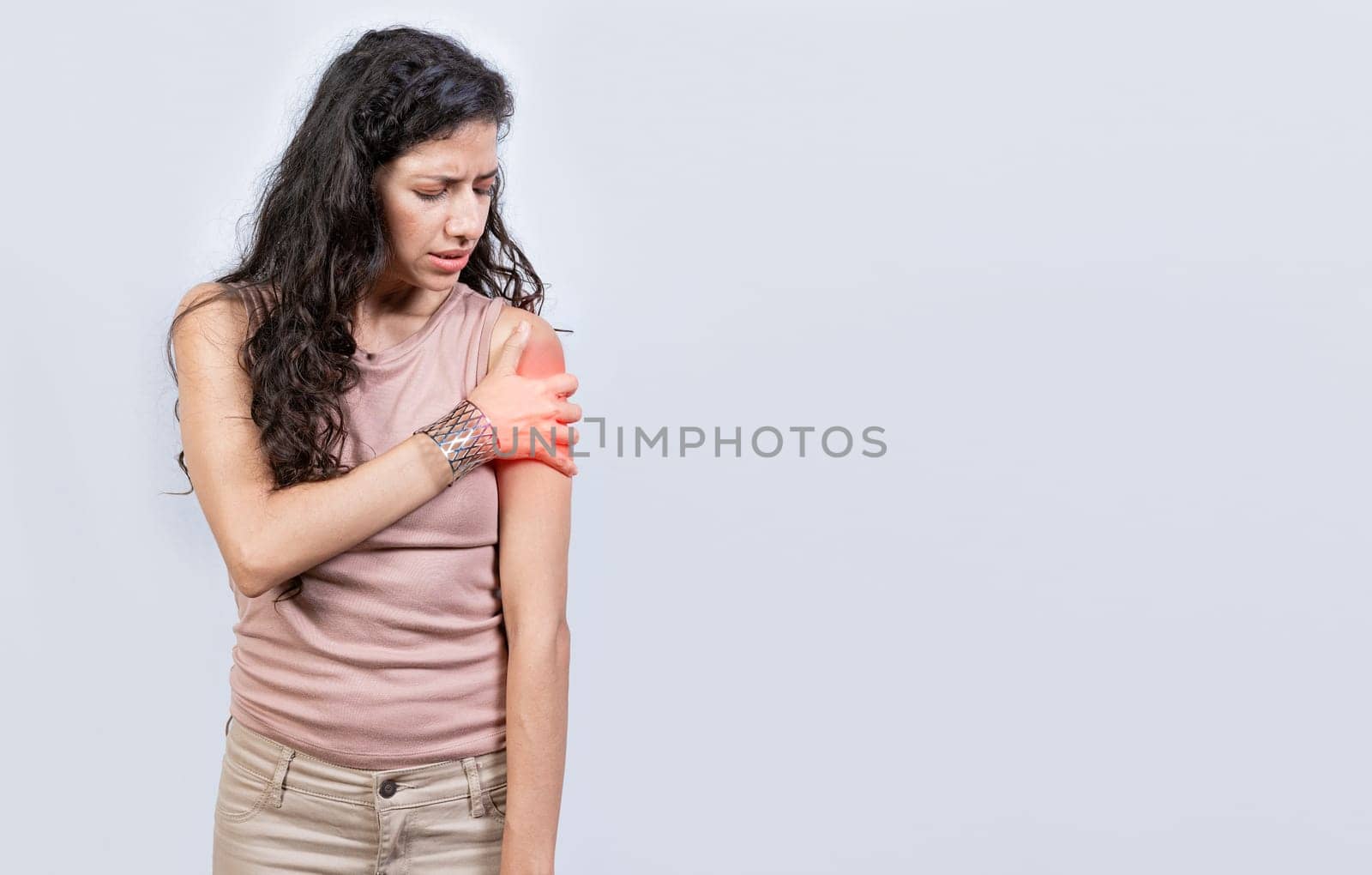 Sore young woman with arm pain isolated. Woman suffering with arm pain, Woman with shoulder and arm pain on isolated background