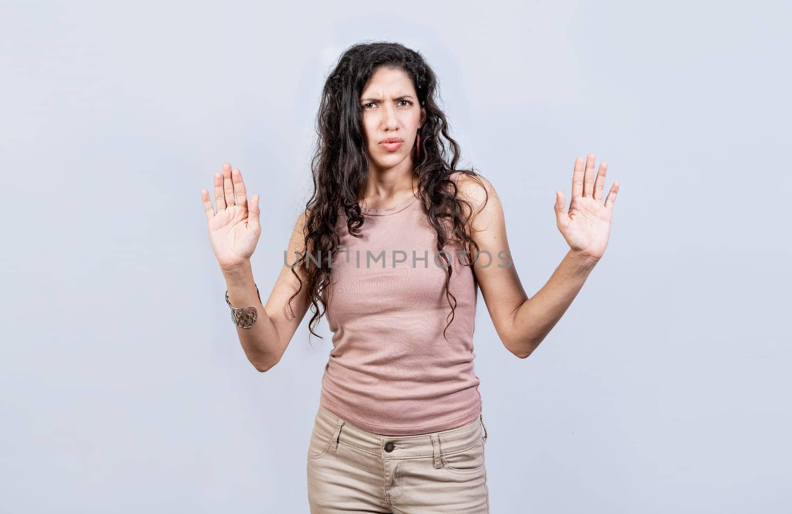 Scared woman with raised hands isolated. Young woman with scared face with raised hands, Scared and horrified girl with raised palms by isaiphoto