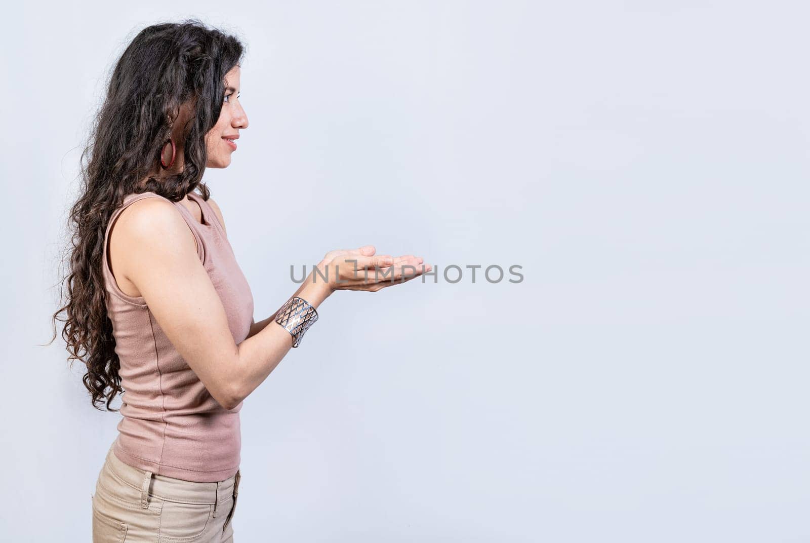 Smiling girl recommending a product with her hands, Young woman recommending an advertisement with the palm of her hands. Product recommendation concept