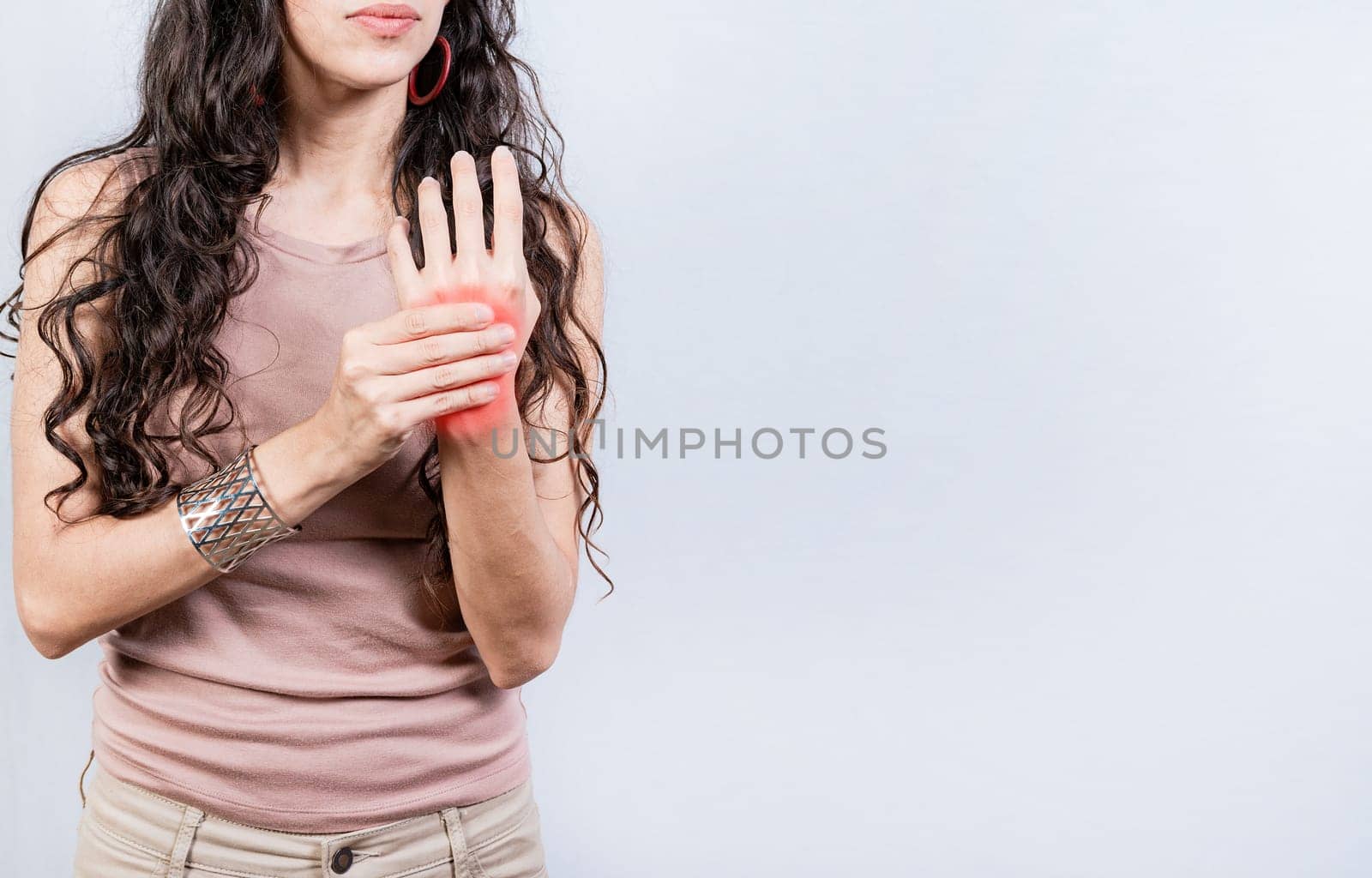 Girl suffering with joint pain of hands. People with arthritis and hand pain isolated. Woman suffering from arthritis in her hands by isaiphoto