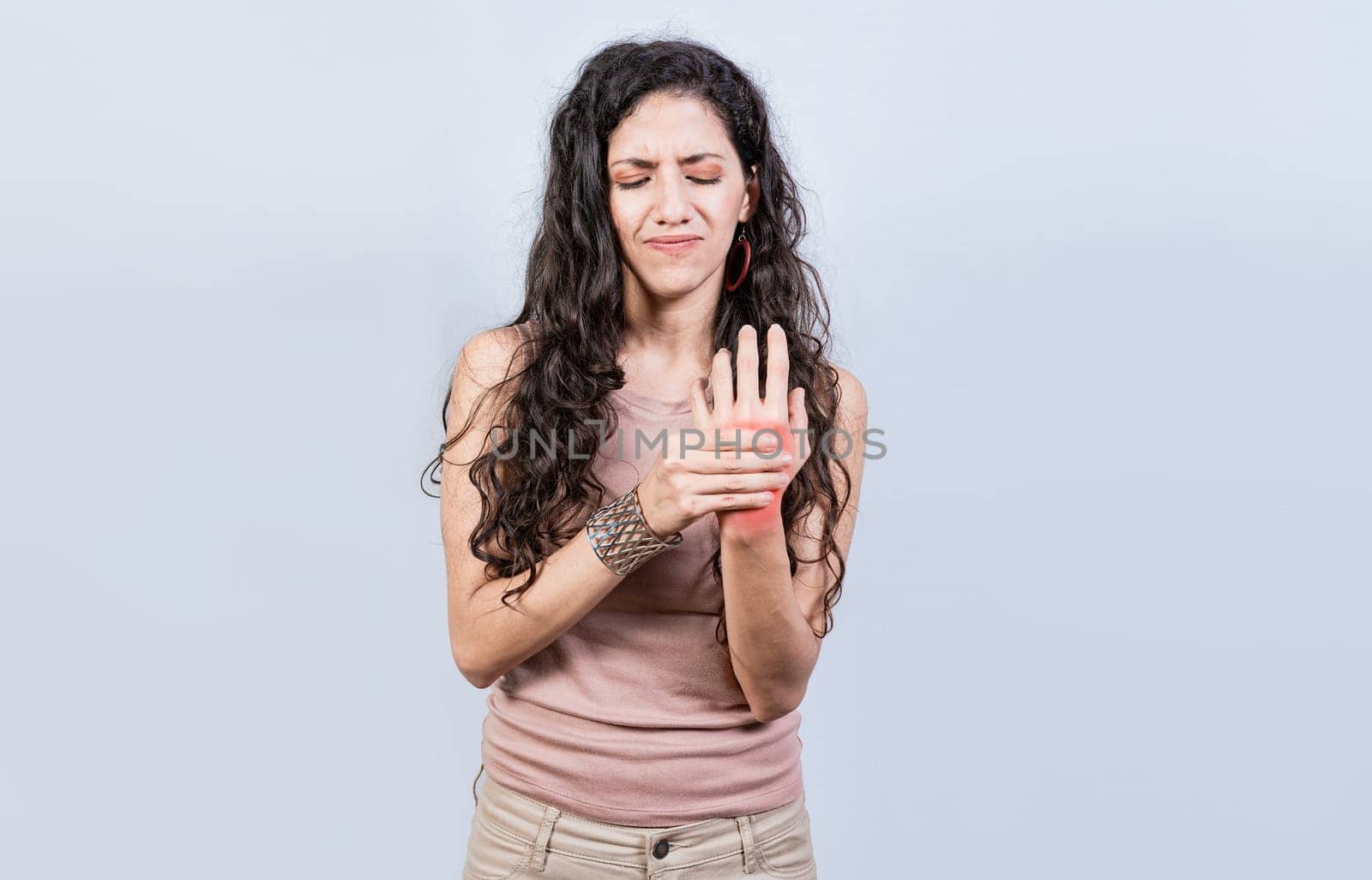 Woman suffering from arthritis in her hands. People with arthritis and hand pain isolated, Girl suffering with joint pain of hands by isaiphoto