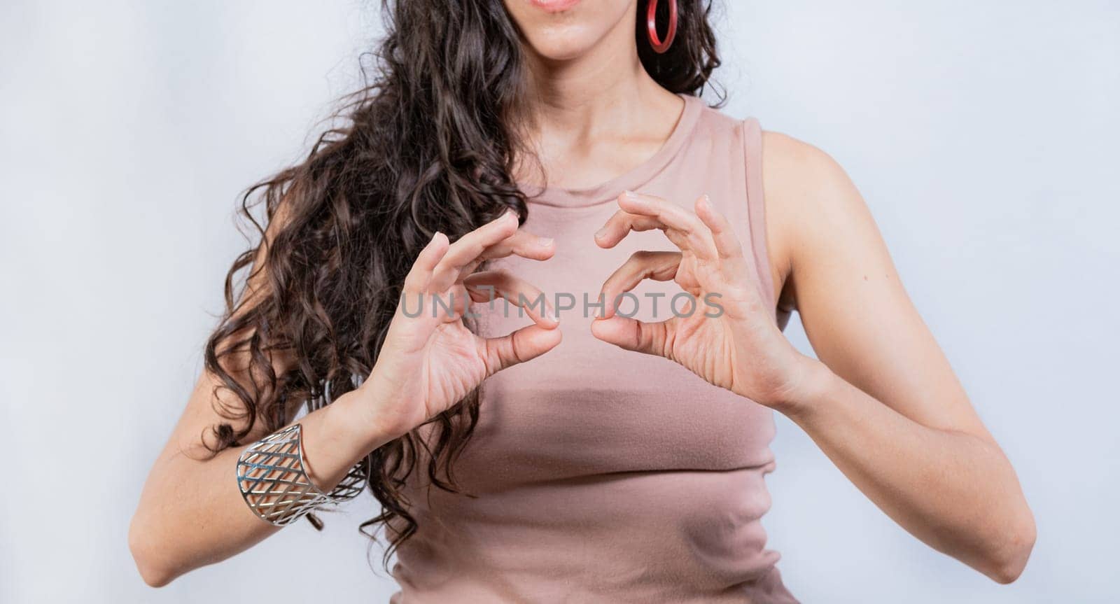 Interpreter gesturing in sign language. People gesturing in sign language isolated. Unrecognizable woman gesturing in sign language by isaiphoto