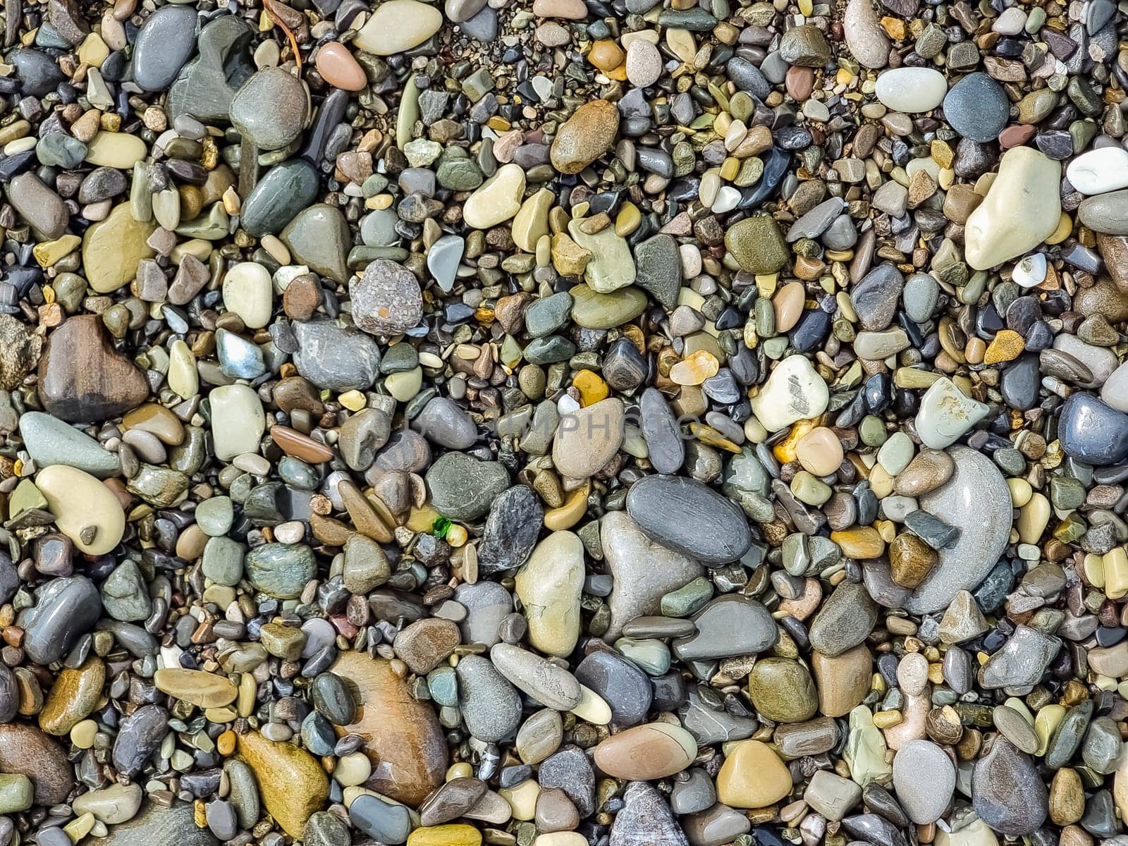 Small round stones background. Stone texture. Rough surface of small pebble stone.