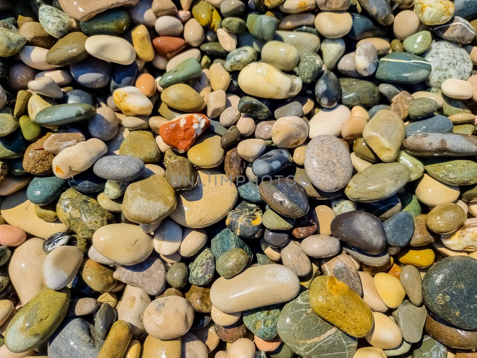 Small round stones background. Stone texture. Rough surface of small pebble stone.