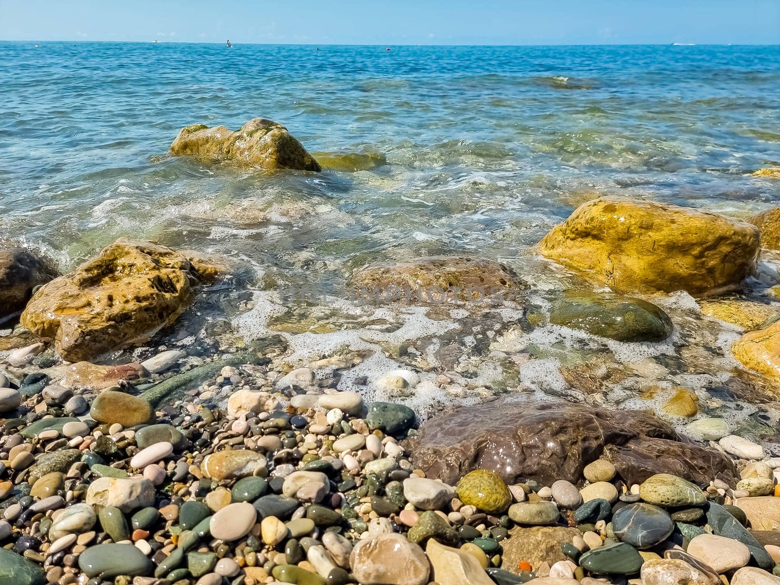 Stones on beach and sea water