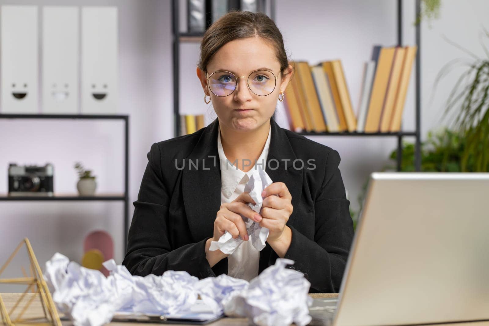 Angry furious business woman working at office throwing crumpled paper having nervous breakdown at work migaine headache stress management, mental distress problems, losing temper, reaction on failure