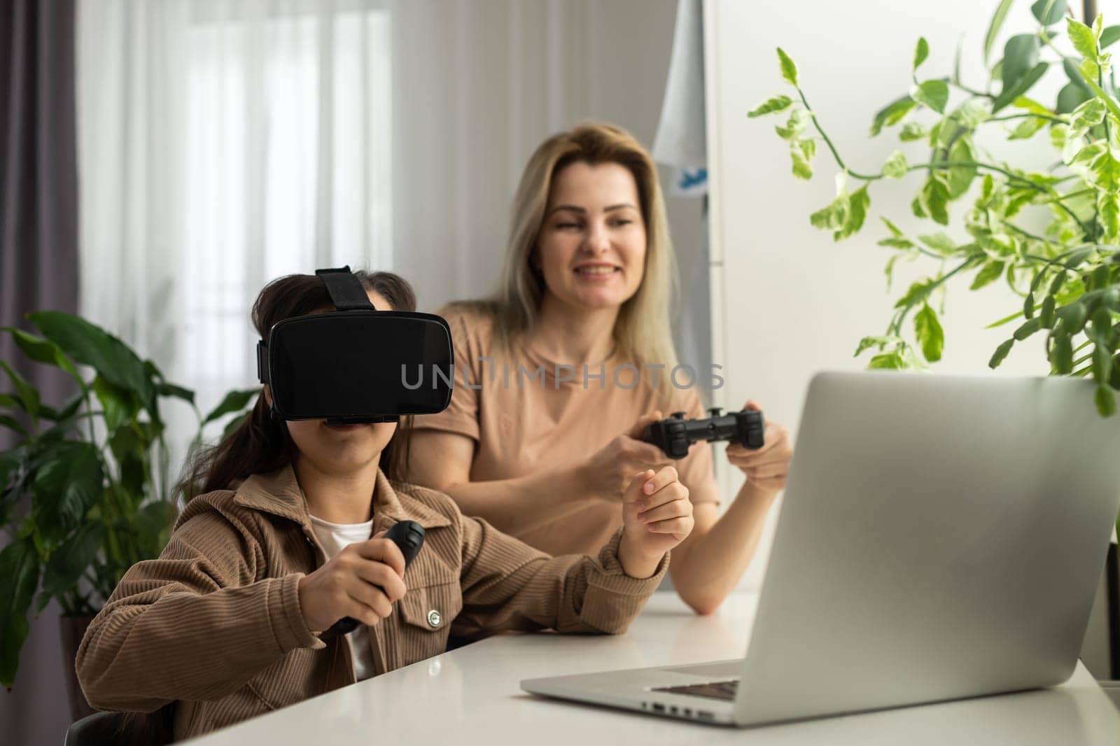 family, technology and virtual reality concept - mother and daughter in vr glasses playing at home. by Andelov13