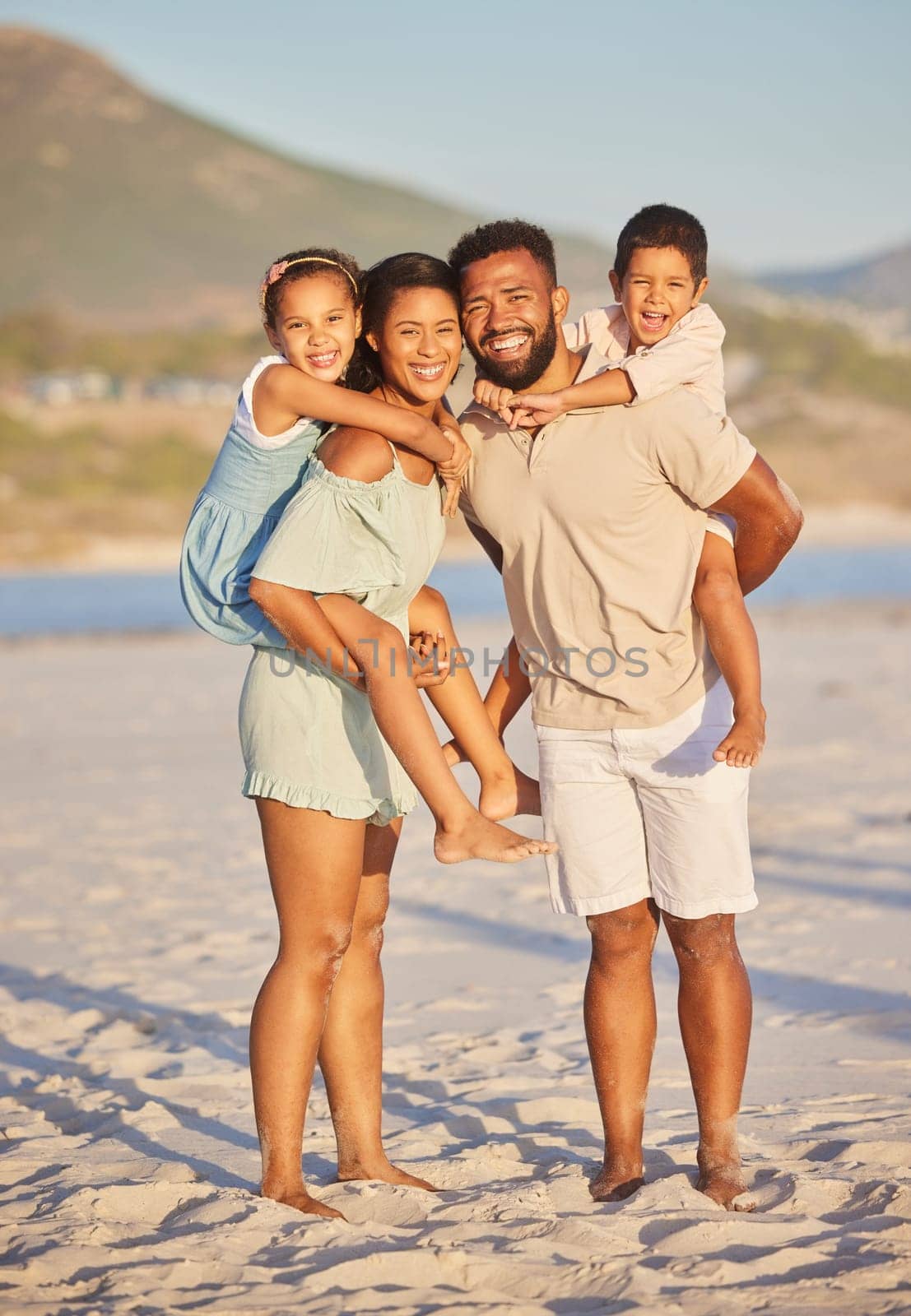 Mother, father or portrait of happy kids at beach to travel with a smile, joy or love on holiday vacation. Mom, piggyback or dad with children as a family in Mexico with wellness bonding together.