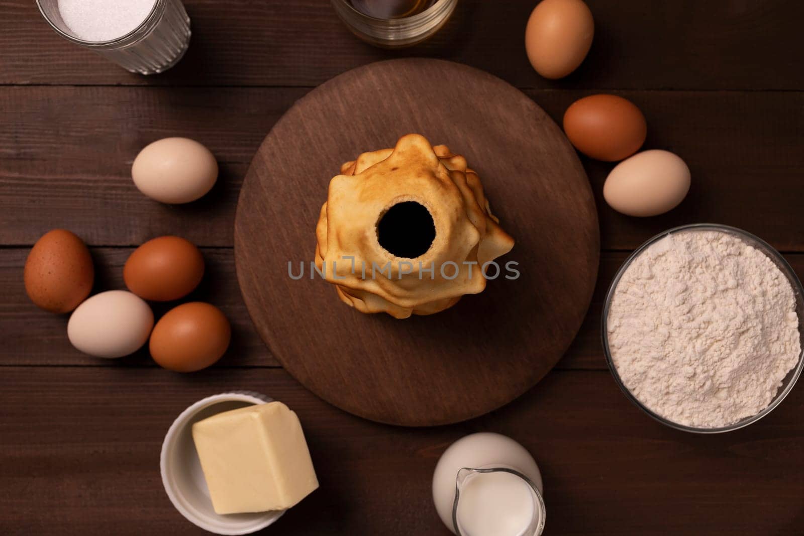 Top view baumkuchen, sakotis ,sekacz ingredients on wooden table, traditional spit cake of lithuanian, polish, german, belarusian cuisine made of butter, eggs, flour, sugar. Horizontal plane.