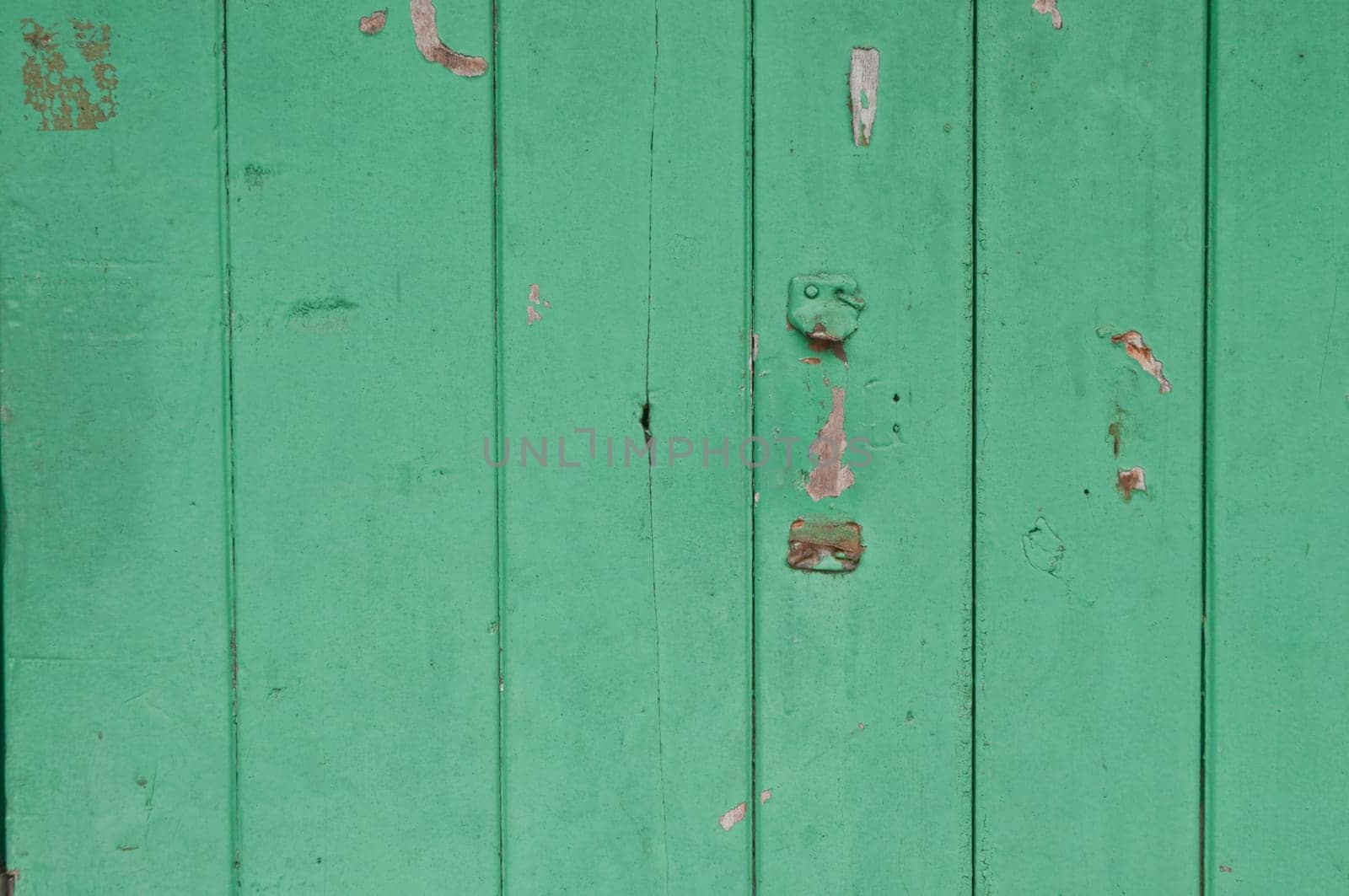 Dark bright lemonade lime green wooden old door with broken placeholder of handle by eyeofpaul