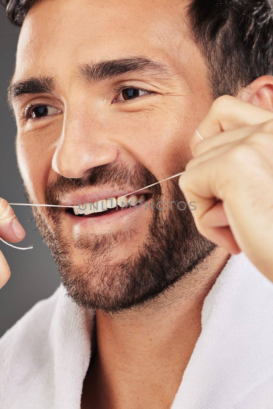 Man, teeth and face smile for dental floss, skincare or cosmetics for fresh clean or healthy hygiene. Closeup of bearded male flossing toothy mouth for oral, dermatology or gum care treatment by YuriArcurs