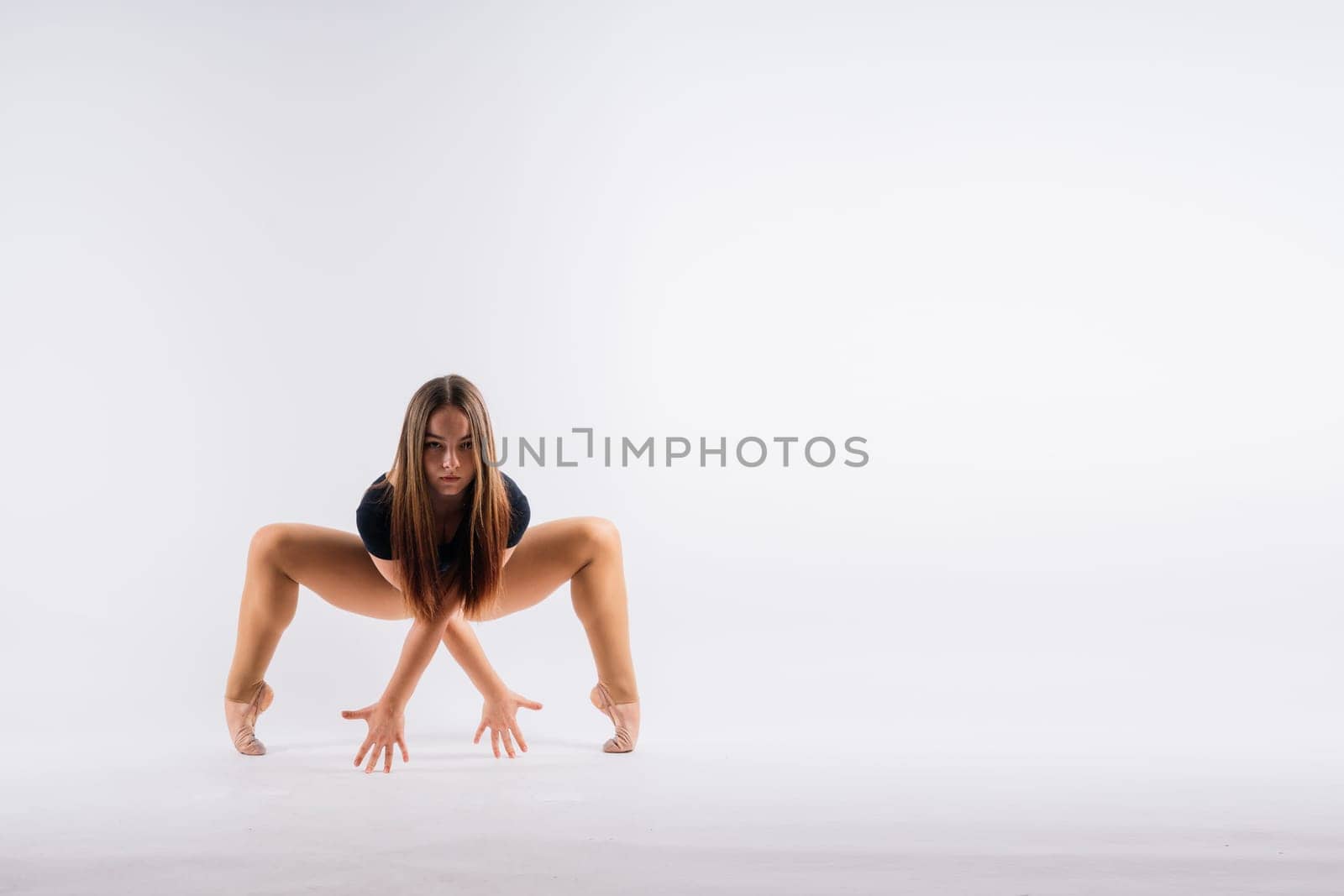 Full length portrait of plump woman doing physical exercise, jump, white and black background.