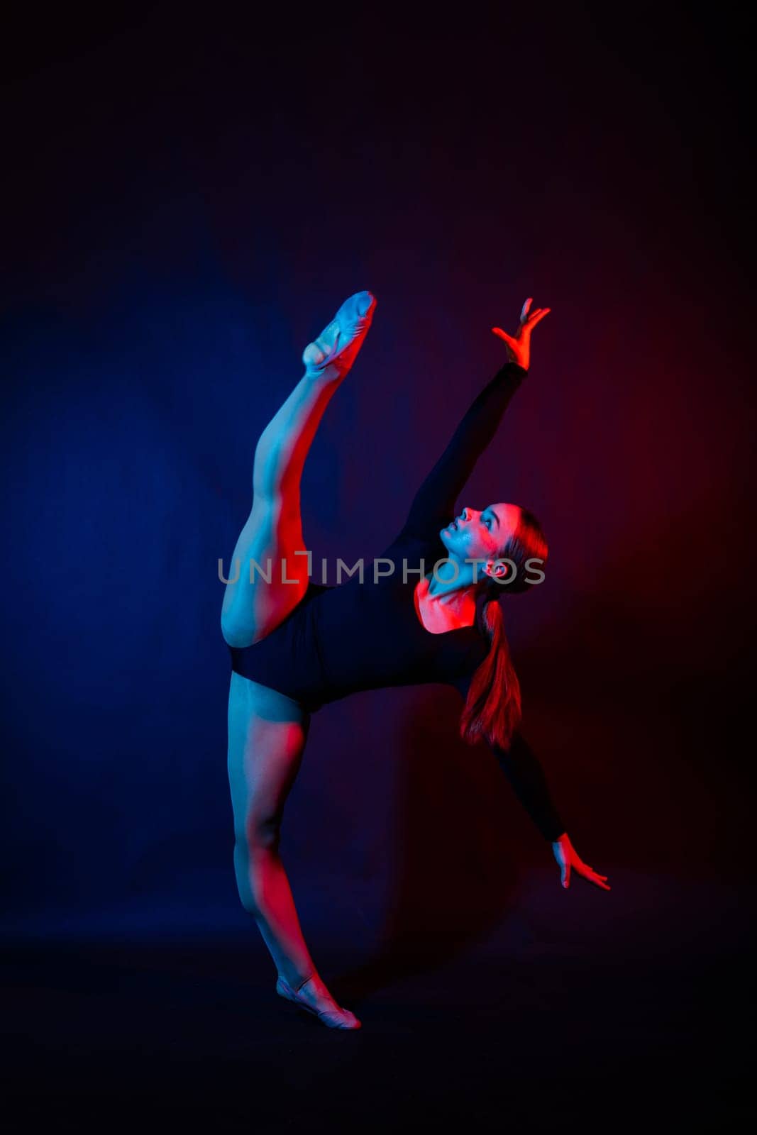 Full length portrait of plump woman doing physical exercise, jump, white and black background.