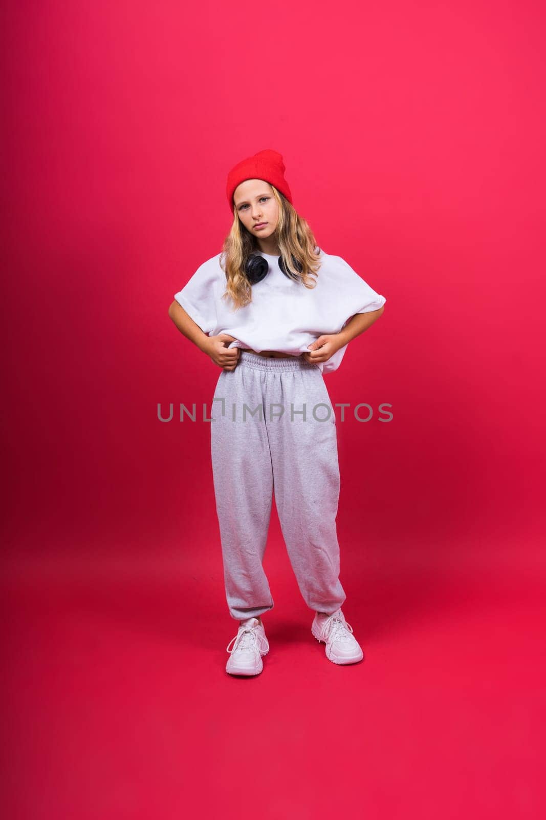 Little kid girl 12,13, 14 years old isolated background. Happy teenager, positive and smiling.