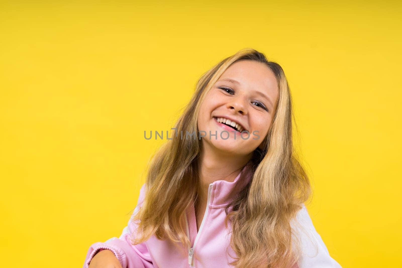 Little kid girl 12,13, 14 years old on isolated background. Happy teenager, positive and smiling. by Zelenin