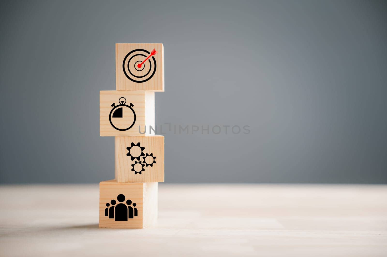 Business target concept with wooden block step. Action Plan and Goal icons represent success. Company strategy and project management on a table. Teamwork background.