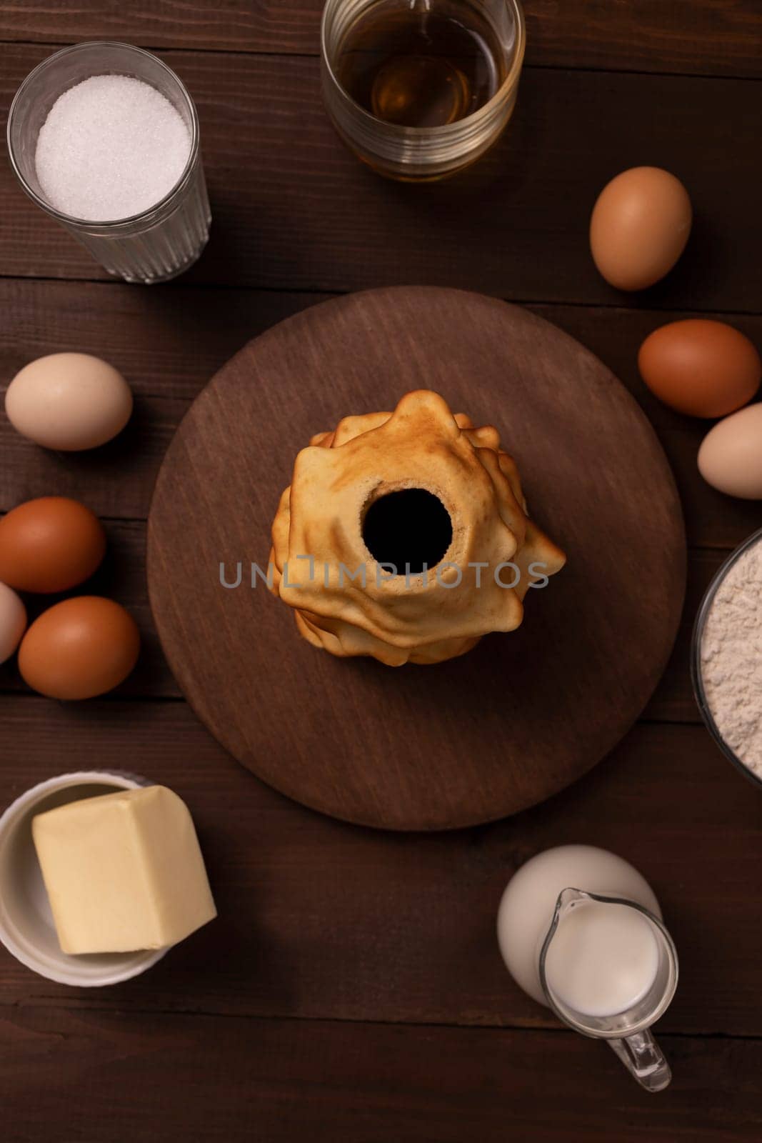 Top view of ingredients for baking baumkuchen, sakotis ,sekacz on wooden table, traditional spit cake of lithuanian, polish, german,belarusian cuisine made of butter,eggs, flour,sugar. Vertical plane