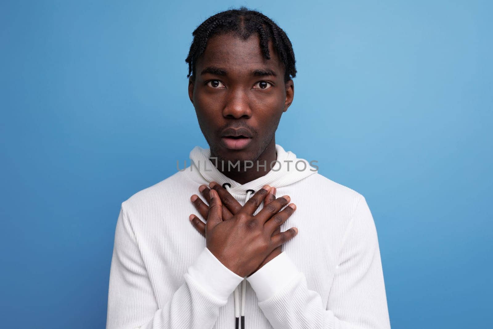 inspired charming man young brunette african man on blue isolated background by TRMK