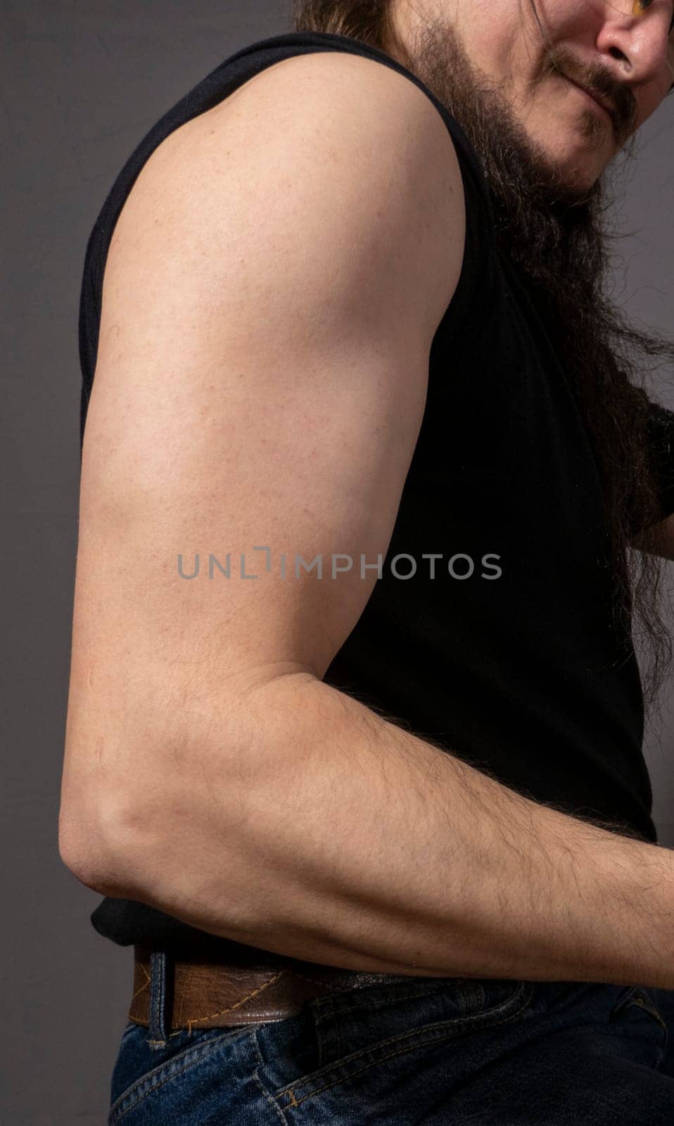 the man shows his hands, arms. Mockup for tattoo on gray background. High quality photo