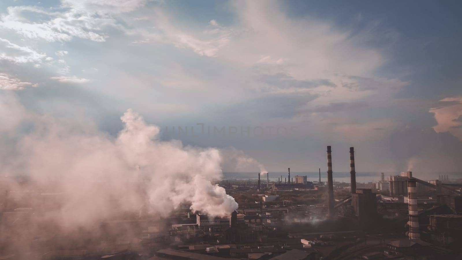 smoke from the chimney. view point of smoking chimney with orange white colors. steam and smoke coming out of factory pipes, industrial zone with dirty air