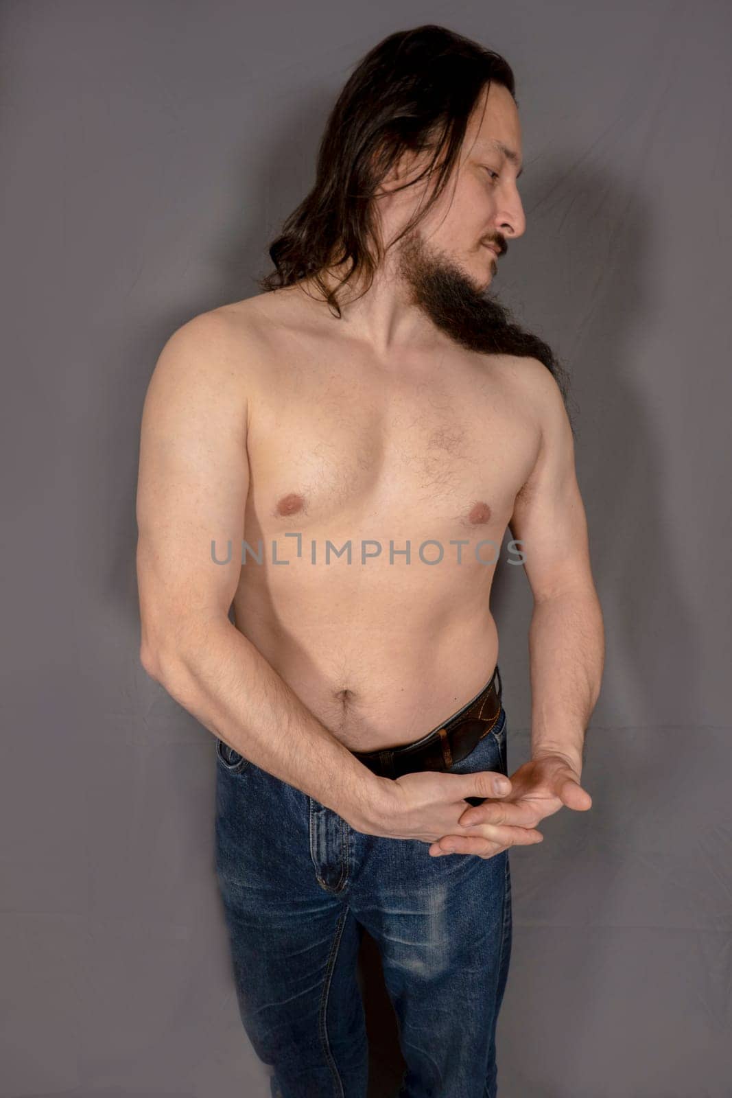 Young confident muscular man. A young man studio portrait.