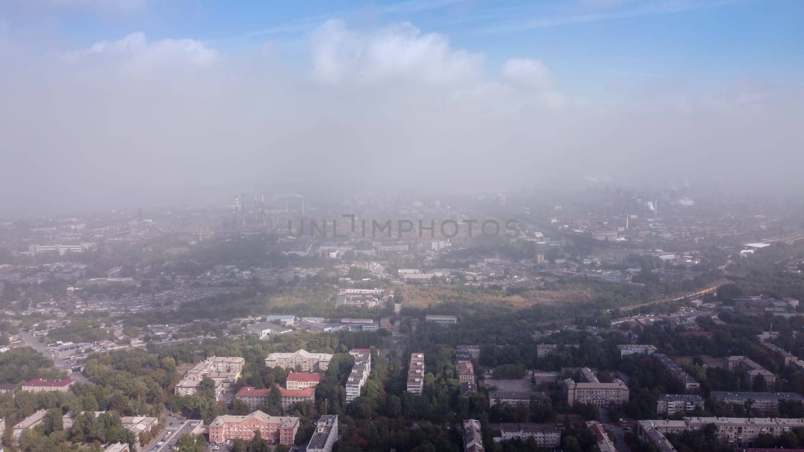 Smog over the city, bird eye view. Aerial view of smog. Cities and industrial smoke clouds the sky. Air pollution. City smog