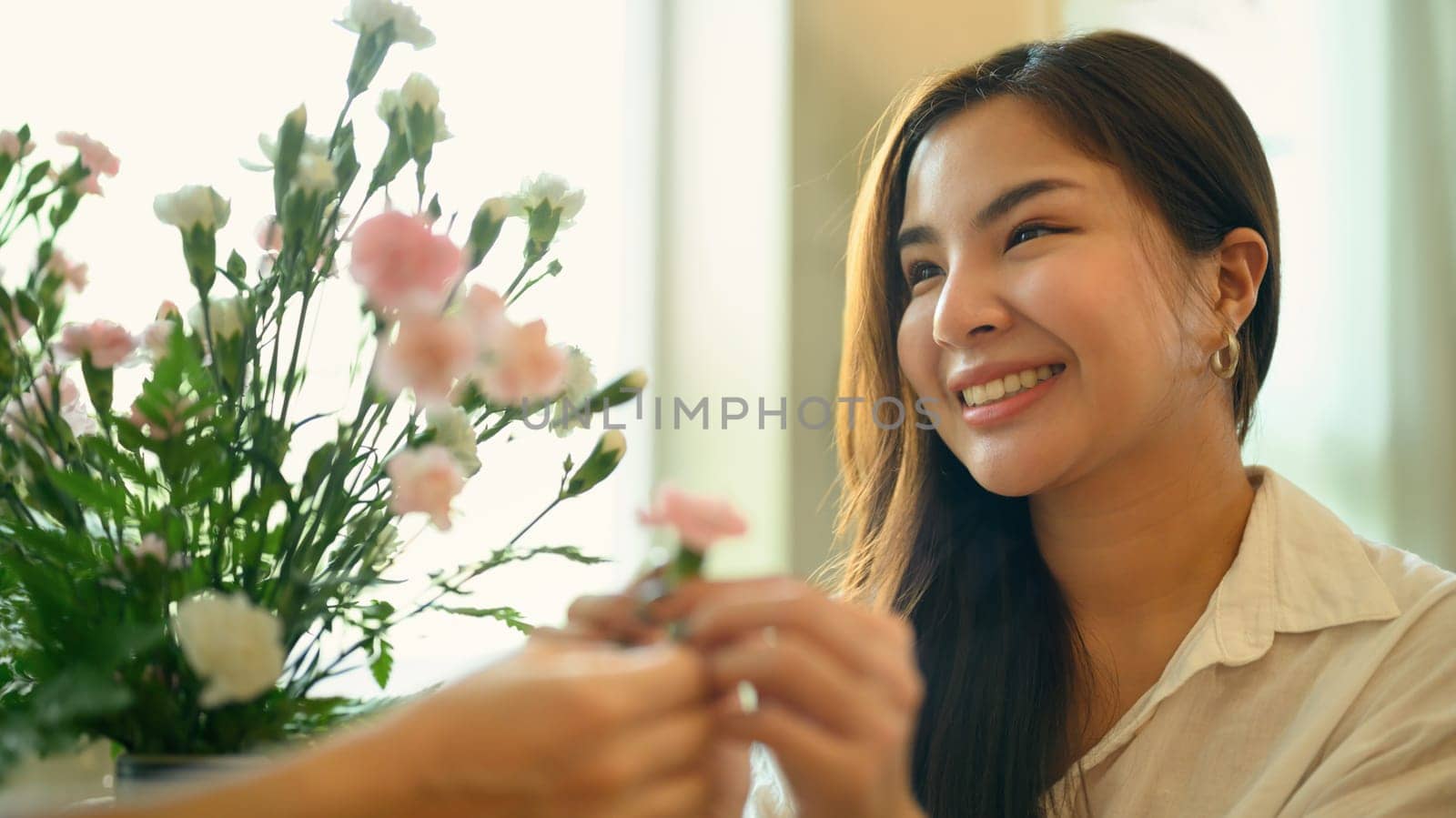 Attractive adult asian woman giving flower to her mother. Happy mother's day, love and family concept by prathanchorruangsak