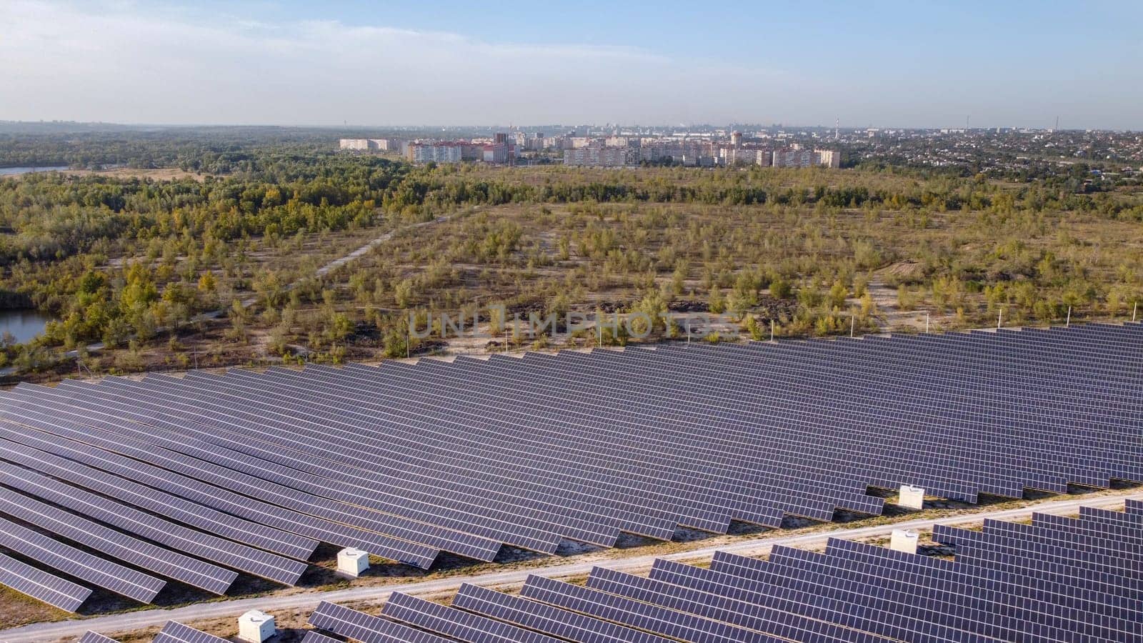 Solar energy farm. High angle, elevated view of solar panels on an energy farm far from city. aerial view on solar panels.