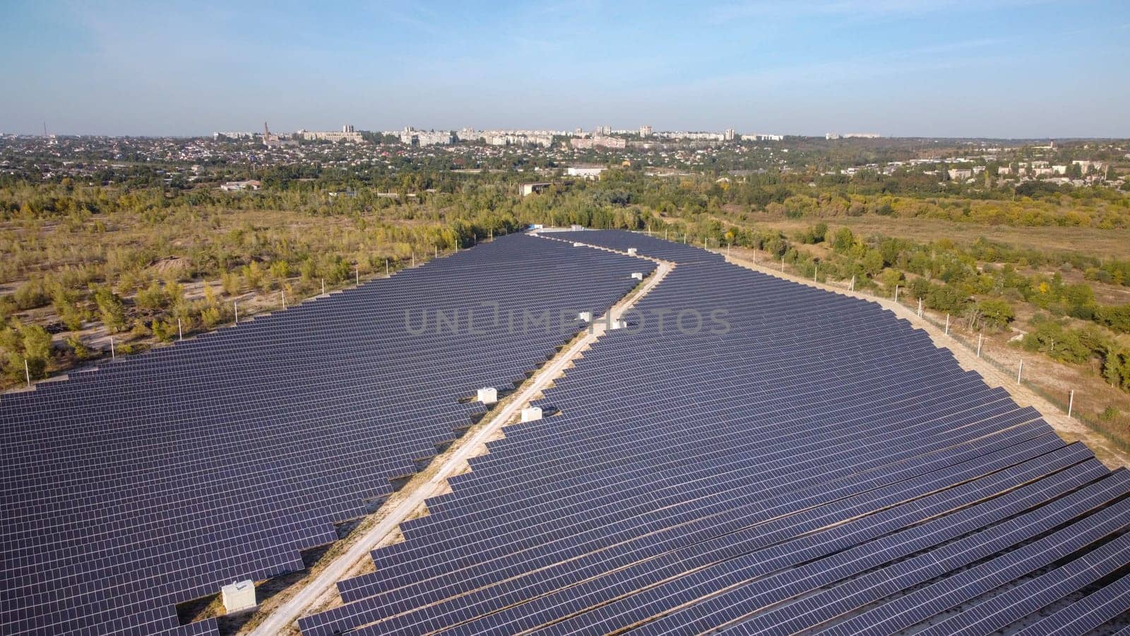 Solar energy farm. High angle, elevated view of solar panels on an energy farm far from city. aerial view on solar panels.