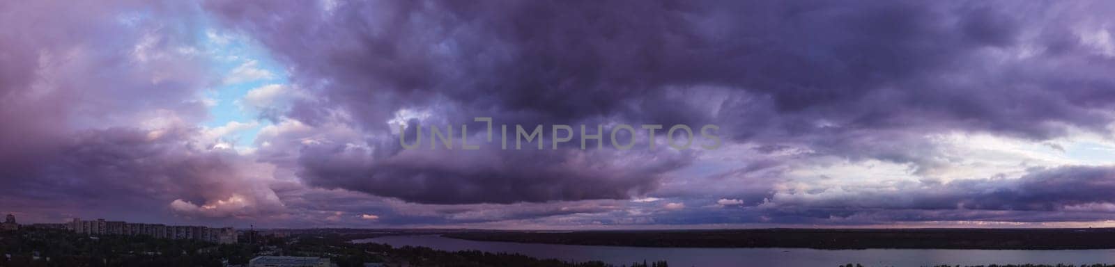 purple sunset with clouds over the city. sky panorama with colorful clouds for wallpaper design. dramatic cloud sky. Aerial view