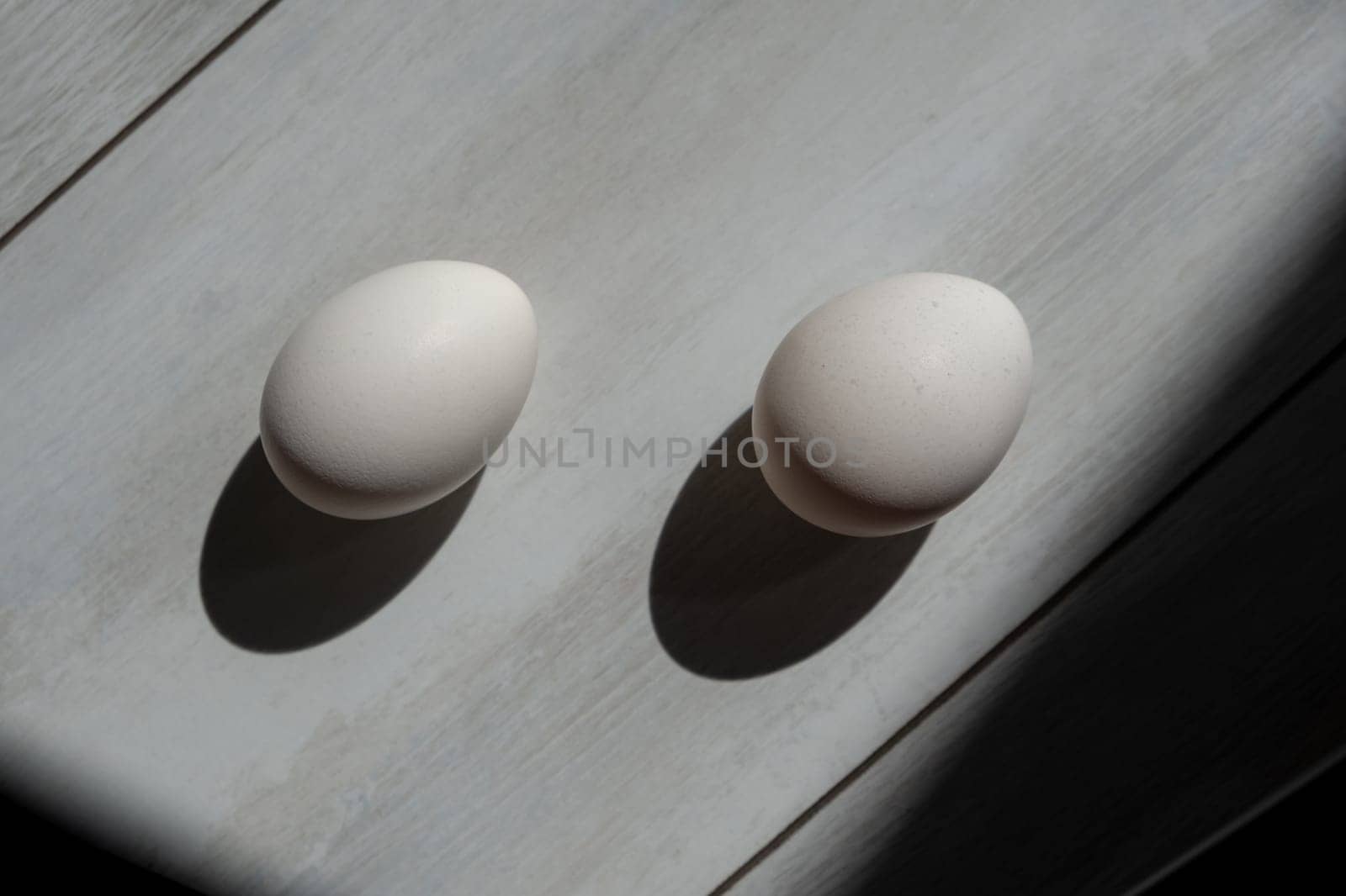 two white eggs on wood background. protein by igor010