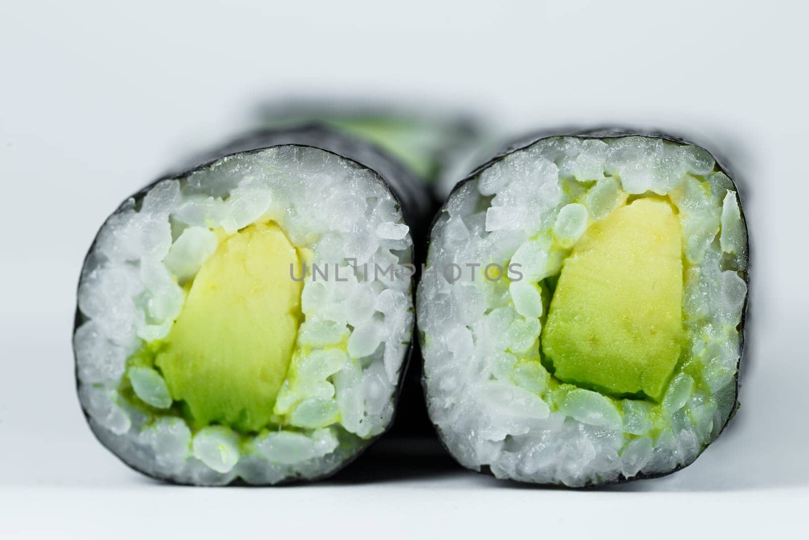 Japanese food. Rolls with ripe avocado, fresh rice with vegetables in nori. Vegetarian rolls