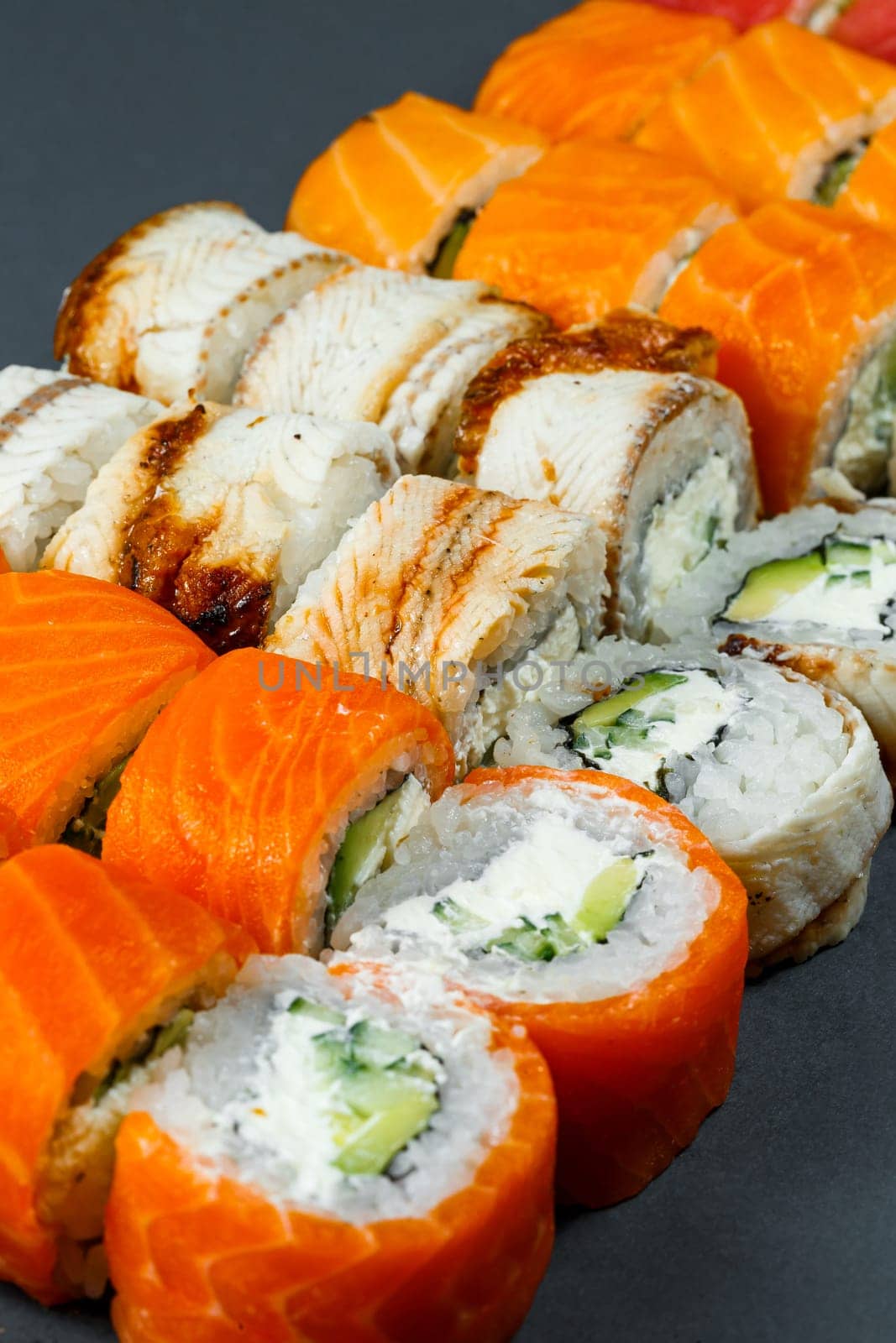 Japanese traditional food. Set of sushi rolls philadelphia with fresh salmon avocado and cream cheese and soy sauce