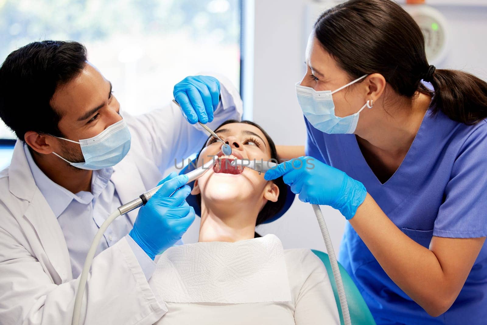Gentle care in the dentists chair. a young woman having a dental procedure performed on her