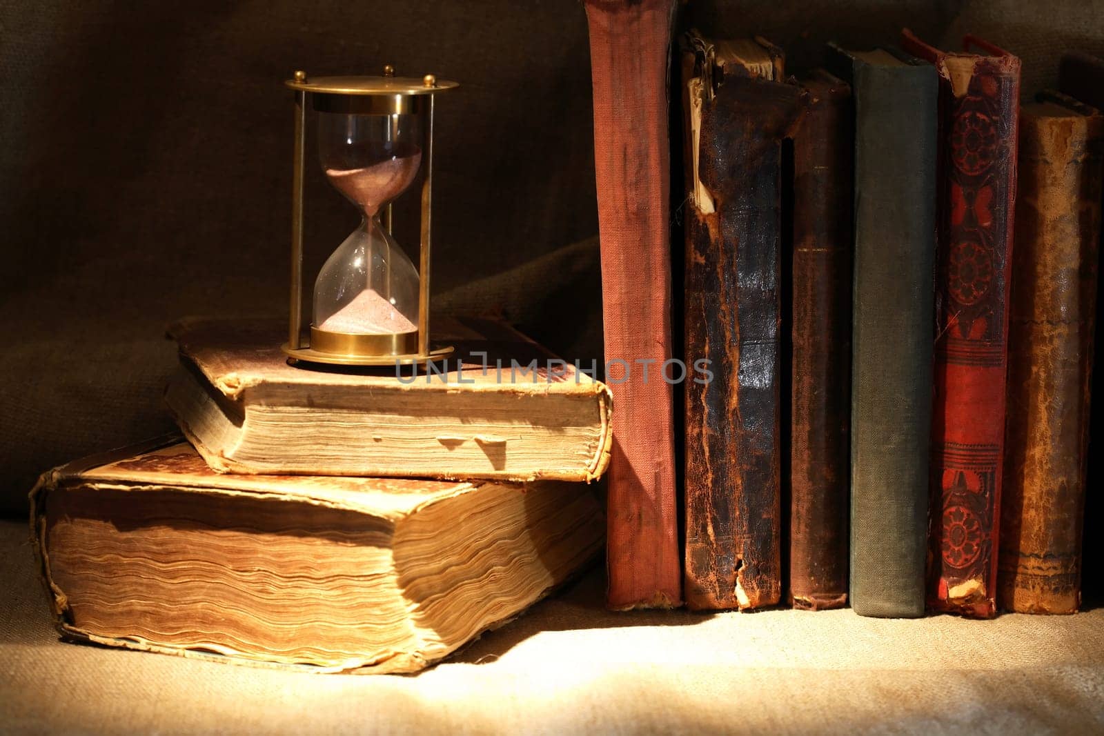 Nice vintage still life with old hourglass and old books