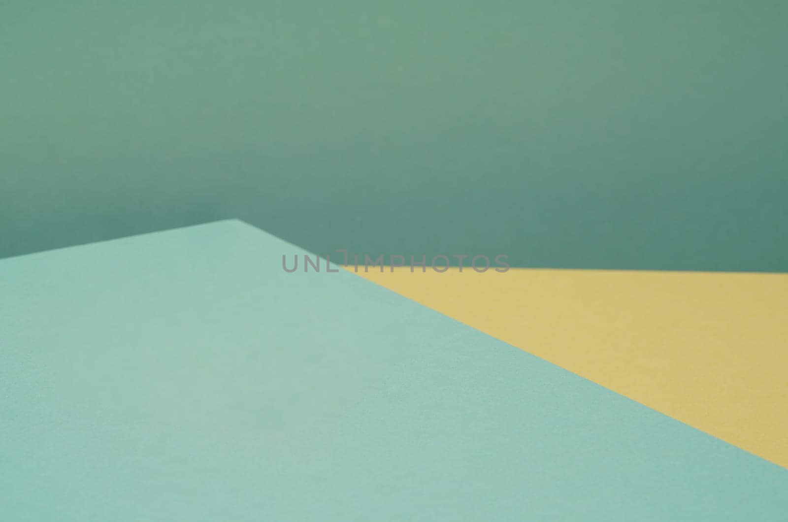 Colorful background from green and yellow paper with shadow. Abstract geometric