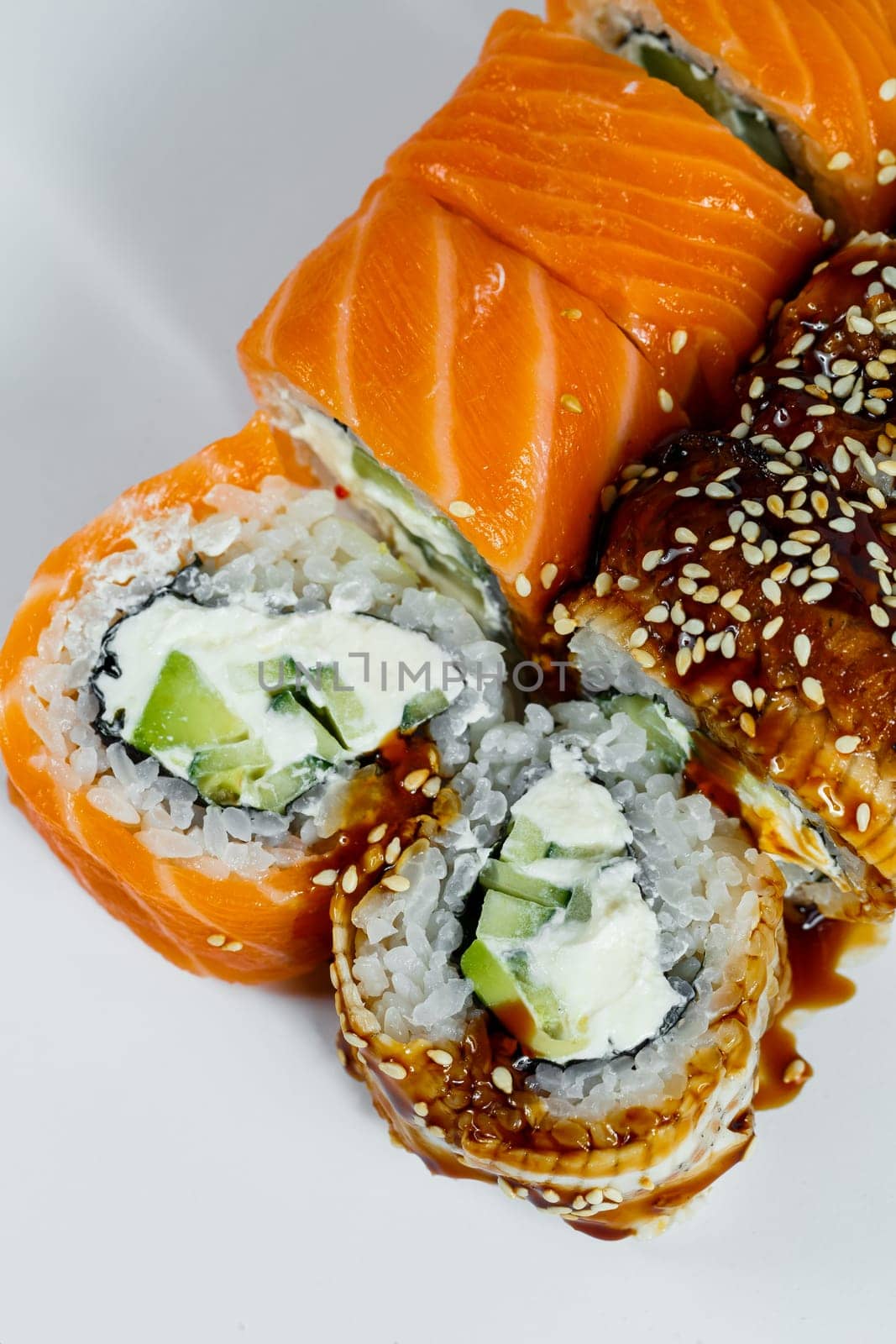 Sushi assorted. Sushi roll with avocado, cucumber. Sushi roll with salmon and caviar. Sushi roll with tuna and caviar. On a light background. Japanese food. View from above