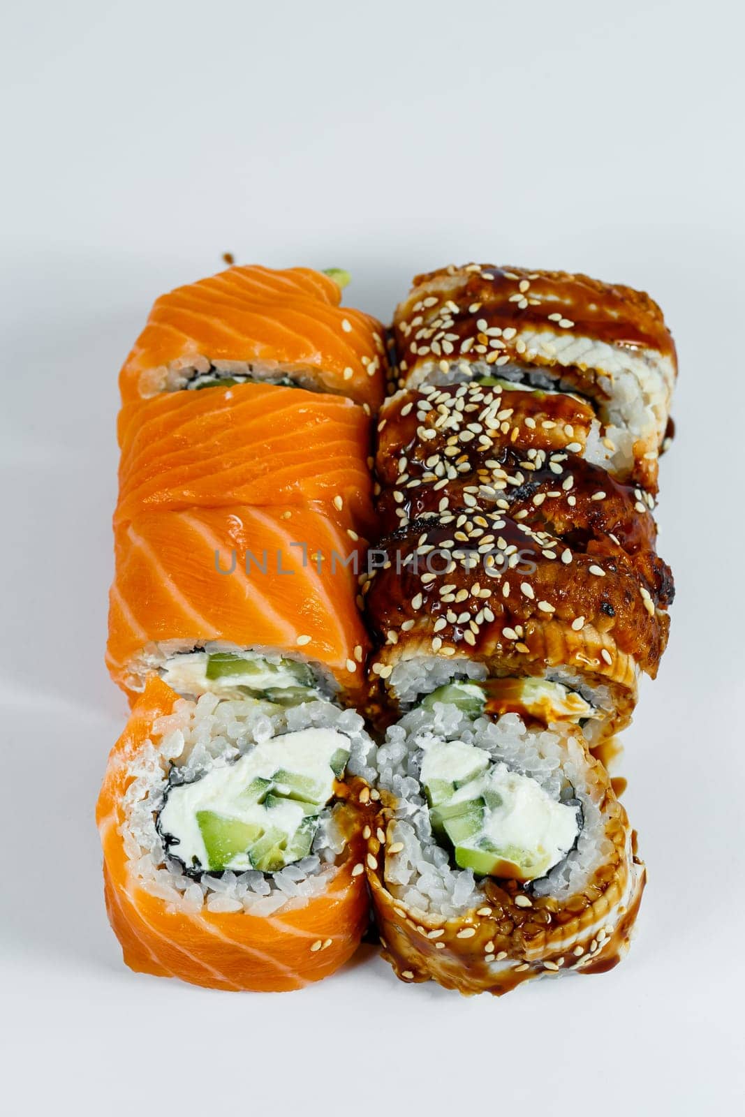 Sushi assorted. Sushi roll with avocado, cucumber. Sushi roll with salmon and caviar. Sushi roll with tuna and caviar. On a light background. Japanese food. View from above