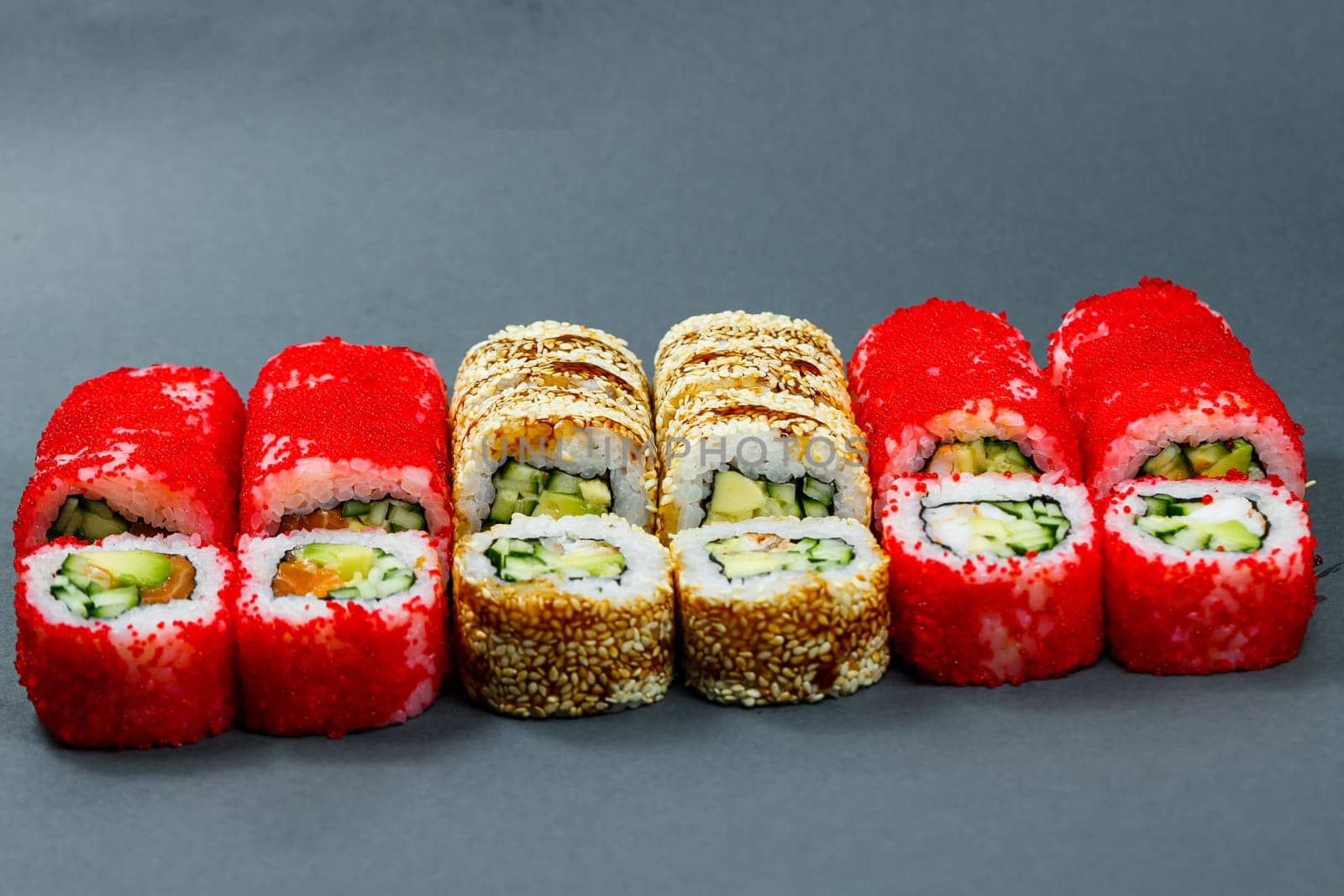 Sushi assorted. Sushi roll with avocado, cucumber. Sushi roll with salmon and caviar. Sushi roll with tuna and caviar. On a light background. Japanese food. View from above