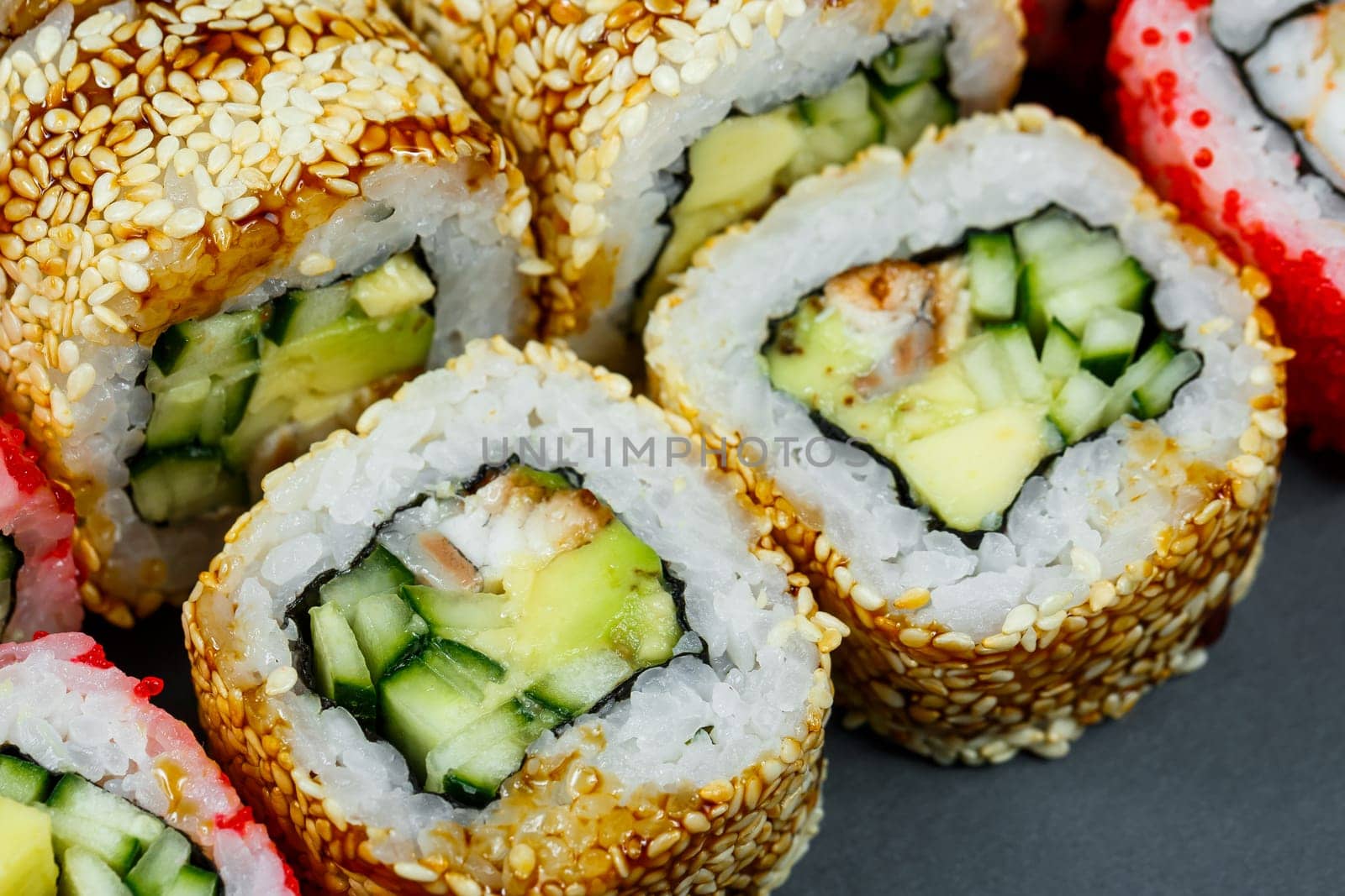 Sushi assorted. Sushi roll with avocado, cucumber. Sushi roll with salmon and caviar. Sushi roll with tuna and caviar. On a light background. Japanese food. View from above