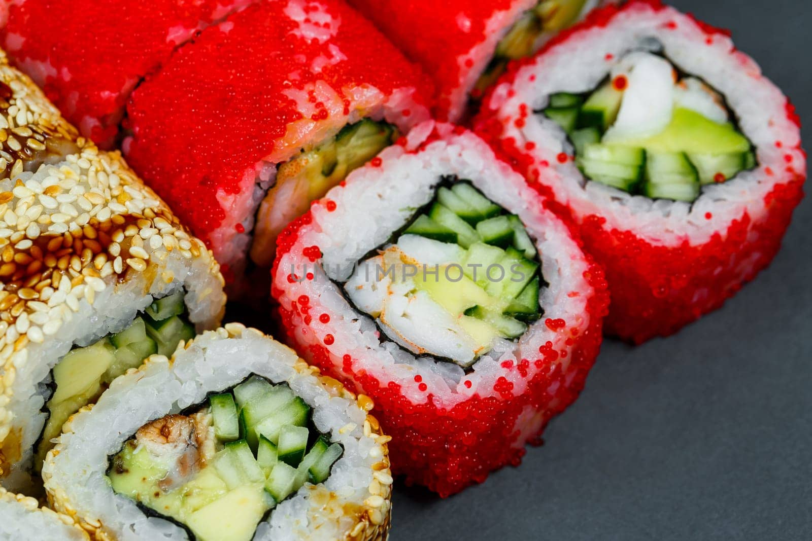 Sushi assorted. Sushi roll with avocado, cucumber. Sushi roll with salmon and caviar. Sushi roll with tuna and caviar. On a light background. Japanese food. View from above
