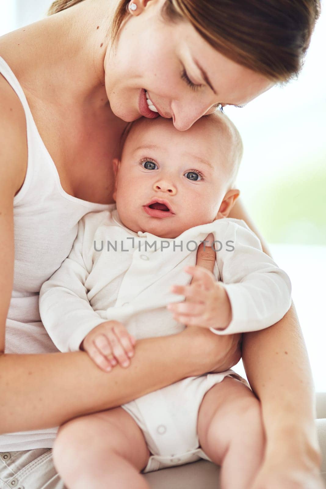 Shot of an adorable baby boy bonding with his mother at home.