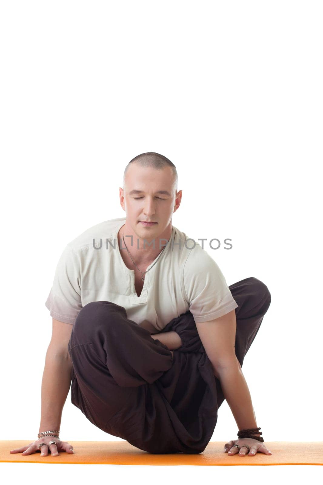 Studio shot of meditator man in difficult asana by rivertime