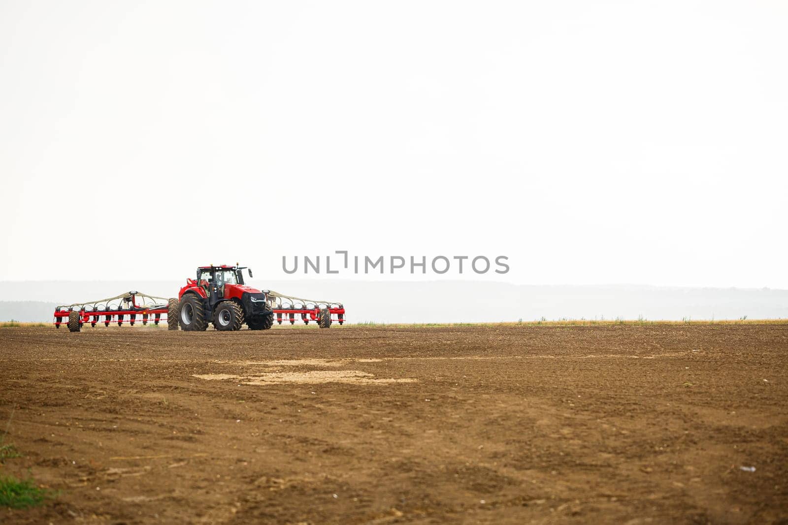 Large modern tractor for preparing the field after winter for sowing grain. Agricultural machinery