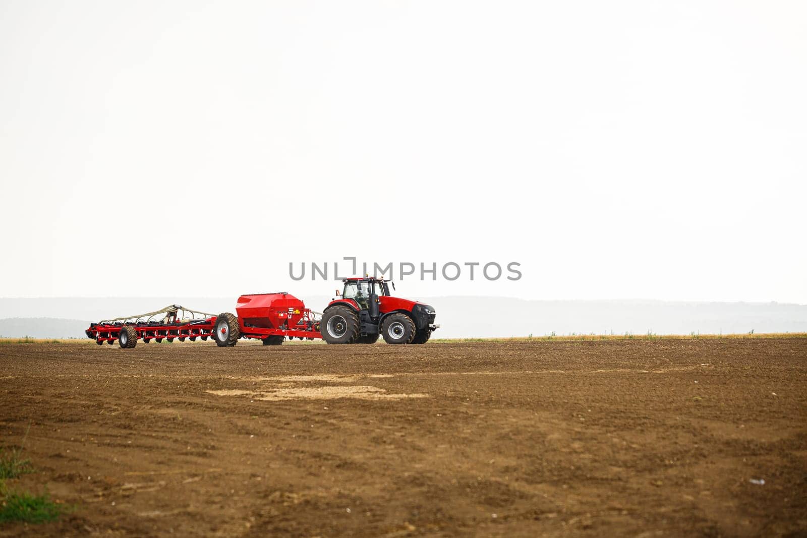 Large modern tractor for preparing the field after winter for sowing grain. Agricultural machinery