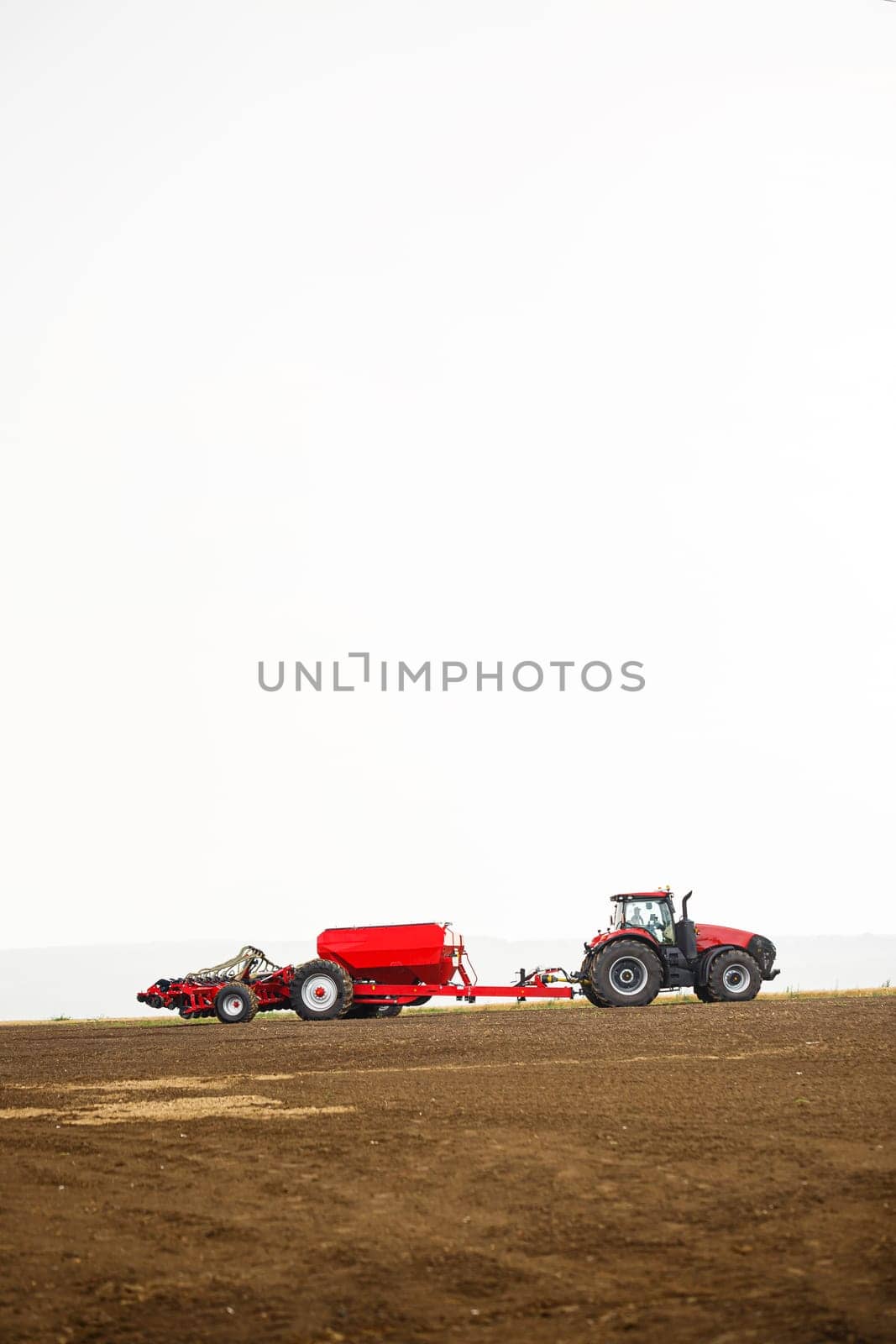 Large modern tractor for preparing the field after winter for sowing grain. Agricultural machinery