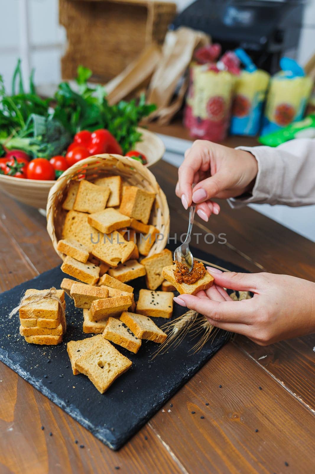 Slices of toasted bread and pate in female hands. Fresh croutons made of whole grain flour