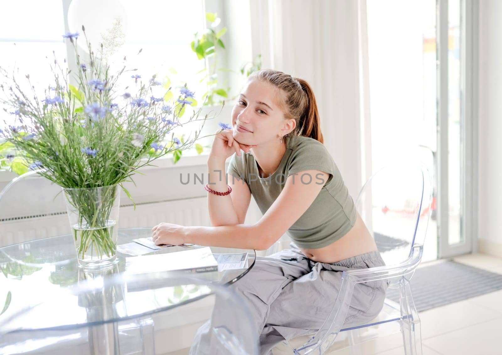 Beautiful girl teenager sitting by table by tan4ikk1