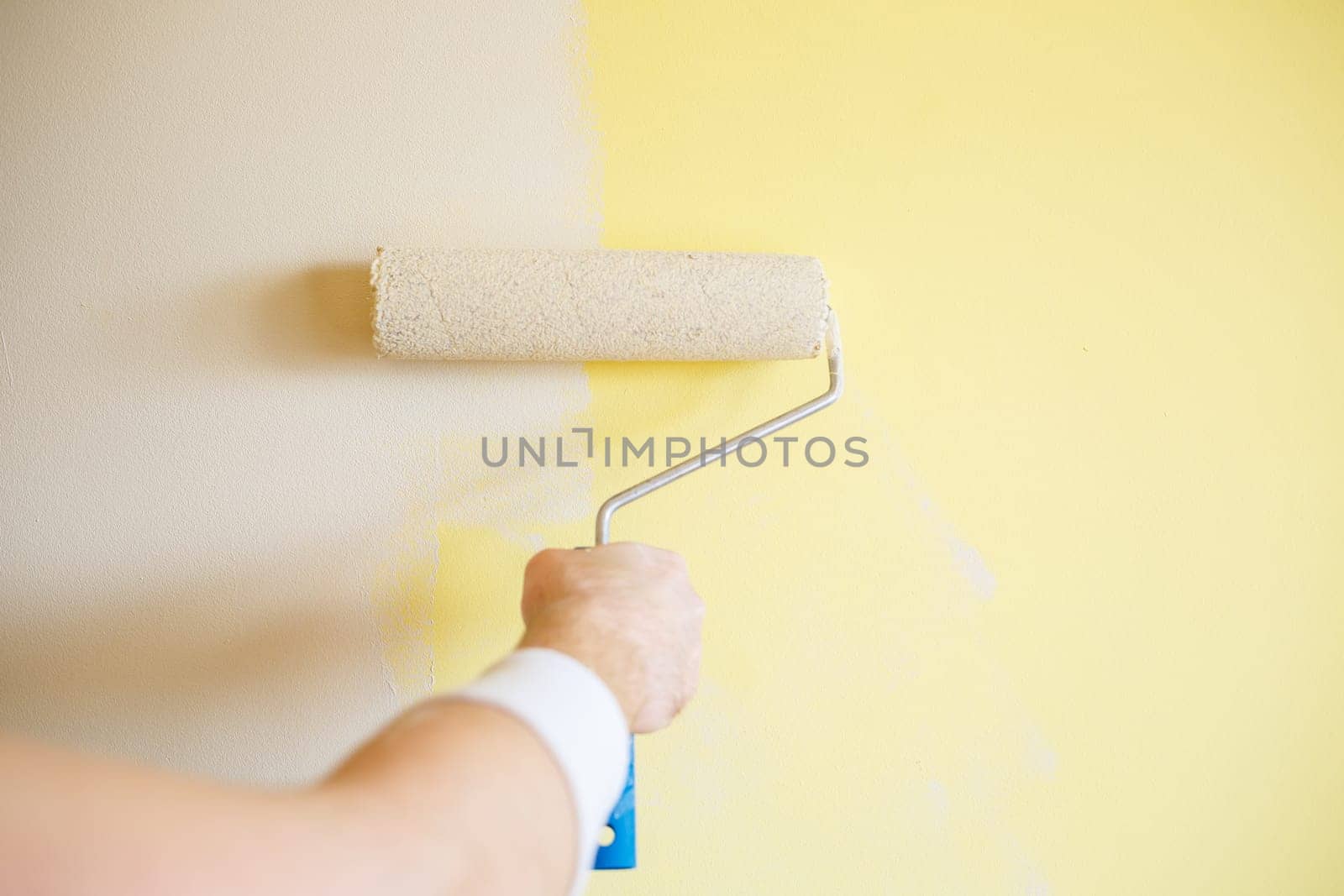 Professional wall painting, roller painting on interior walls. Renovation concept